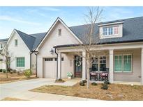 Charming exterior of a painted brick home featuring a covered front porch and attached garage at 5229 Noble Village Way, Lilburn, GA 30047