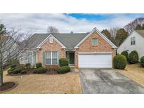 Charming single-story home with brick facade, well-maintained landscaping, and a two-car garage at 916 Santa Anita Dr, Woodstock, GA 30189