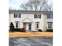 A charming townhome featuring symmetrical design elements, bay windows, and a well-kept yard at 1625 Conley Rd # 171, Conley, GA 30288