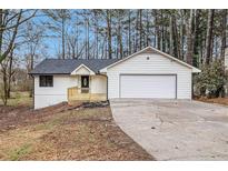Charming single story home featuring a front-facing garage and a small front porch at 6276 Willowbrook Dr, Riverdale, GA 30296