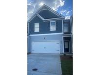 Charming home featuring a two-car garage and well-maintained landscaping at 1029 Northfield Dr, Conyers, GA 30013