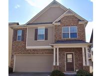 Charming two-story home with a brick facade, attached garage, and inviting entrance at 2463 Turnbury Glen, Snellville, GA 30078
