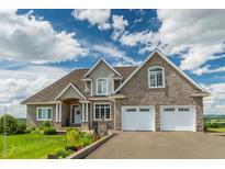 Charming two-story home with stone facade, attached two car garage and well-manicured lawn at 546 Palm St, Holly Springs, GA 30115