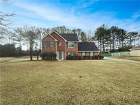 Charming two-story brick home with a well-maintained front yard and mature trees at 7782 Wethersfield Dr, Jonesboro, GA 30236