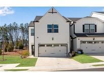 Modern two-story home with a white brick exterior and a spacious two-car garage at 1733 Hyssop Blvd, Mableton, GA 30126