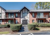 Charming two-story condo with brick facade, balconies, and well-maintained landscaping at 6851 Roswell Rd # H1, Sandy Springs, GA 30328