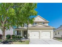 Charming two-story home featuring a well-manicured lawn, mature trees, and a convenient two-car garage at 4310 Alysheba Dr, Fairburn, GA 30213