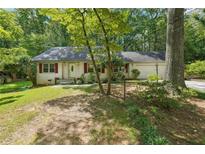 Charming single-story home with a well-manicured front yard and brick facade at 6565 Katie Ln, Morrow, GA 30260