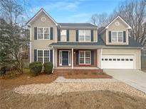 Charming two-story home with attached garage, landscaped front yard and welcoming entrance at 1997 Alcovy Trace Way, Lawrenceville, GA 30045