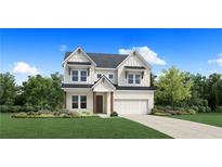 Charming two-story home with a brick facade, a well-manicured lawn, and lush landscaping at 3021 Sunset Pass, Canton, GA 30114