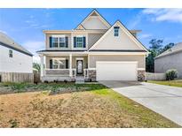 Charming two-story home featuring a well-maintained front yard and a two-car attached garage at 1353 Wilson Manor Cir, Lawrenceville, GA 30045