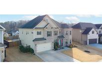 Stunning two-story home featuring a brick and siding exterior with a well-manicured lawn and attached two-car garage at 5160 Meridian Pass, Cumming, GA 30028