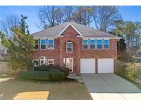 Two-story brick home featuring a two-car garage and traditional architectural details at 3744 Misty Wood Nw Dr, Marietta, GA 30064