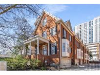 Attractive brick townhome featuring a charming covered porch and bay window at 774 Piedmont Ne Ave # 1B, Atlanta, GA 30308