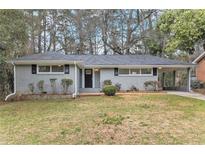 Charming, single-story home with a well-maintained lawn and a classic painted brick facade at 1145 Canal St, Decatur, GA 30032