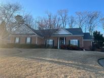 Charming brick home featuring a well-maintained lawn and inviting curb appeal at 1415 Fountain Cove Ln, Lawrenceville, GA 30043