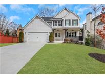 Charming two-story home with a manicured lawn, a two-car garage, and a welcoming front porch at 2383 Colonial Ne Dr, Brookhaven, GA 30319