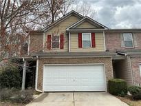 Attractive townhouse with a white garage door and red shutters at 1281 Rockfield Cir, Norcross, GA 30093