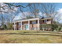 Classic two-story brick home with white columns and a well-manicured lawn showcases timeless appeal at 1426 Diamond Head Dr, Decatur, GA 30033