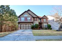 Beautiful two-story home featuring a well-maintained front yard and two car garage at 460 Chandler Bluff Ct, Grayson, GA 30017