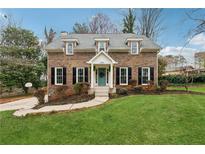 Charming two-story brick home with manicured lawn and inviting front entrance at 3084 Brookshire Way Way, Duluth, GA 30096