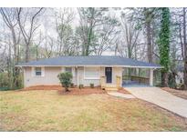 Charming single-story home with a covered carport and a well-maintained front yard at 3651 Tulip Dr, Decatur, GA 30032