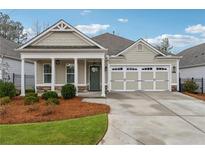 Charming home featuring a two-car garage, covered front porch, neutral siding, and manicured lawn at 48 Lantern Trce, Hiram, GA 30141