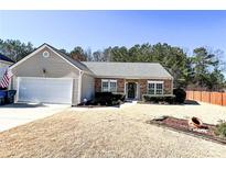 Charming single-story home with stone accents, attached garage, and well-maintained front lawn at 5710 Stephens Mill Dr, Sugar Hill, GA 30518