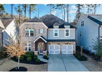 Beautiful two-story home with a brick and siding exterior and well-manicured landscaping at 167 Marlow Dr, Woodstock, GA 30188