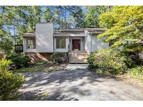 Charming home featuring a well-maintained exterior with a brick chimney and inviting front entrance at 2830 Jodeco Dr, Jonesboro, GA 30236