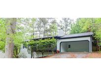 Charming one-story home with a carport and mature landscaping at 6235 Queens Rd, Douglasville, GA 30135