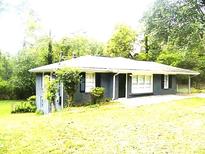 Charming single story home featuring a neutral color, nice yard, and covered carport at 2703 Flagstone Se Dr, Atlanta, GA 30316