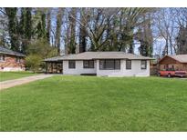Single story house featuring a well manicured lawn, carport and a freshly painted exterior at 1808 Brewer Sw Blvd, Atlanta, GA 30310
