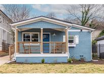Charming blue home with a welcoming front porch, rocking chairs, and stylish number 75 at 75 Mayson Ne Ave, Atlanta, GA 30307