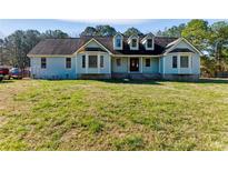 Charming home featuring a well-manicured lawn and traditional architectural details at 1505 Ozora Rd, Loganville, GA 30052