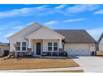 Charming single-story home with a well-manicured lawn and a two-car garage in a suburban neighborhood at 244 Cordova St, Woodstock, GA 30189