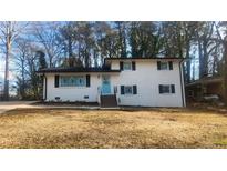 Charming two-story home with a well-maintained yard and delightful blue front door at 2653 Williamsburg Dr, Decatur, GA 30034