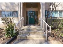 Inviting front entrance with a beautiful arched entry, staircase, and an appealing green door at 3236 Henderson Mill Rd, Atlanta, GA 30341