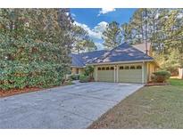 Charming home featuring a spacious two-car garage and a well-maintained, mature landscaped front yard at 1559 Norwood Dr, Lilburn, GA 30047
