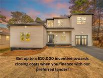 Contemporary two-story home with modern design, neutral siding, and an attached two-car garage at 3444 Underwood Se Ct, Conyers, GA 30013