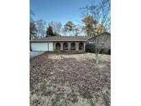 Ranch-style home with a brick facade, arched porch, and a two-car garage at 2944 Williams Pl, Snellville, GA 30078
