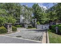 Elegant gated entrance to a private property surrounded by lush landscaping at 4100 Paces Se Walk # 3205, Atlanta, GA 30339