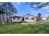 Charming single-story home with a well-manicured lawn and classic white siding at 374 Lamancha Ct, Lawrenceville, GA 30044