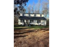 Inviting two-story home featuring a modern design and set against a backdrop of beautiful wooded landscape at 172 White Rose Ln, Temple, GA 30179
