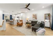 Bright, open-concept living room featuring a modern ceiling fan and seamless flow into the kitchen and dining areas at 383 Pratt Se Dr # 503, Atlanta, GA 30315