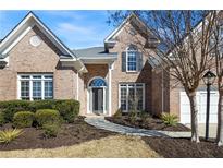 Charming brick home featuring a well-manicured lawn, elegant entryway, and classic architectural details at 1462 Valley Glen Way, Dunwoody, GA 30338