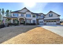 Charming two-story home with a three-car garage, covered porch, and well-manicured lawn at 233 Evening Mist Dr, Acworth, GA 30101