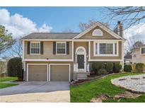 Charming two-story home featuring a well-maintained lawn, two-car garage, and cozy front porch with 'Welcome' sign at 10475 Willow Meadow Cir, Alpharetta, GA 30022
