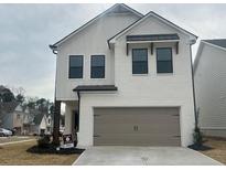 Charming new construction featuring a brick and clapboard facade, and a two-car garage at 4371 Portsbrook Ave, Snellville, GA 30039
