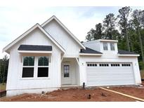 Charming new construction home features a modern farmhouse design, attached garage, and a manicured lawn at 156 Easton Park Blvd, Dallas, GA 30157